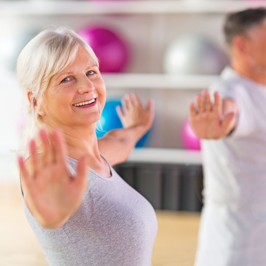 señora haciendo ejercicio en una clase en el gimnasio